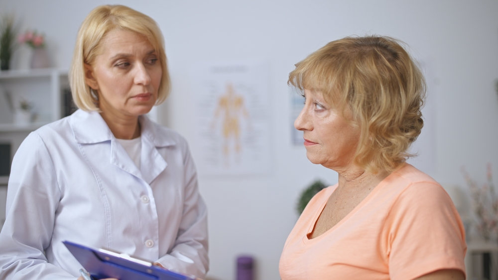 Doctor checking on non compliant patient