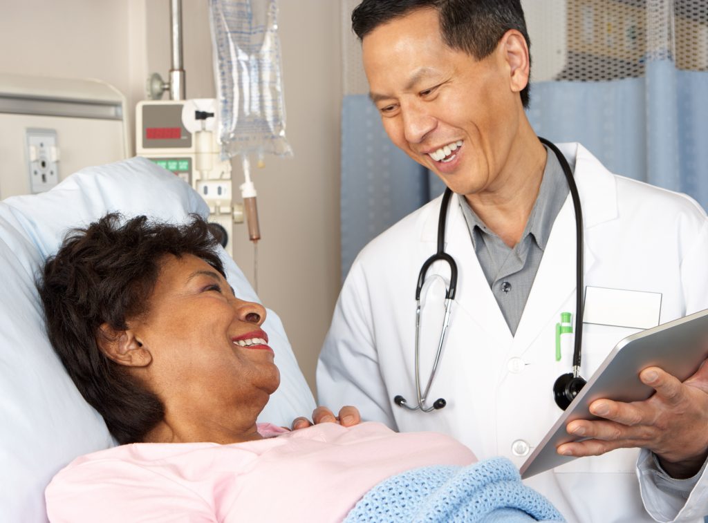 Doctor communicating with patient looking at tablet